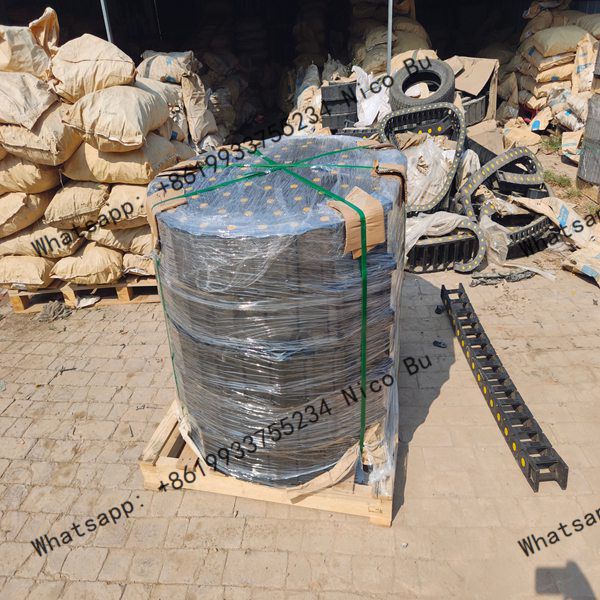 factory-workers-securely-packaging-plastic-cable-drag-chains-in-cartons-for-export-shipping