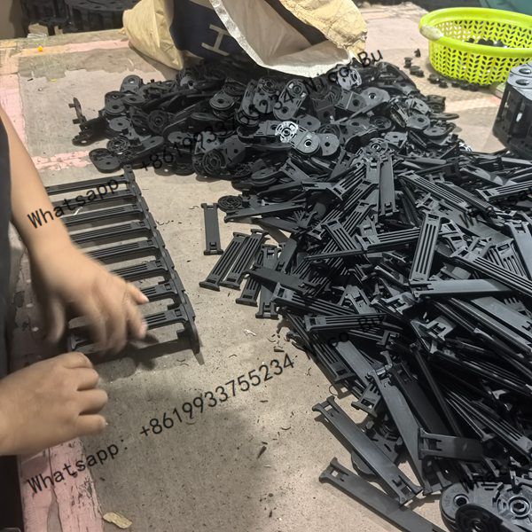 factory-worker-expertly-assembling-plastic-cable-drag-chain-units-on-production-floor